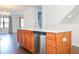 Kitchen island with wooden cabinets, stainless steel dishwasher, and a modern faucet at 9705 Bay Grove Ln, Tampa, FL 33615