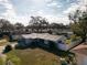 Aerial view of single-story home with large backyard, and mature trees at 1091 Mcfarland St, Dunedin, FL 34698