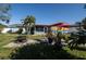 Spacious backyard with fire pit, patio, and colorful mural art at 1091 Mcfarland St, Dunedin, FL 34698