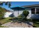 Outdoor seating area with umbrella and manicured lawn at 1091 Mcfarland St, Dunedin, FL 34698