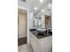 Well-lit bathroom with a sleek vessel sink, black granite countertop, and modern mirrors at 1091 Mcfarland St, Dunedin, FL 34698