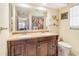 Bathroom featuring double sinks, a vanity with granite countertop, and a modern shower with floral curtain at 1091 Mcfarland St, Dunedin, FL 34698