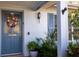 Inviting front door adorned with a wreath and surrounded by lush plants at 1091 Mcfarland St, Dunedin, FL 34698