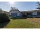 Charming single-story home featuring a well-maintained lawn and attached garage at 1091 Mcfarland St, Dunedin, FL 34698