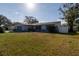 Charming single-story home with well-maintained lawn and mature trees at 1091 Mcfarland St, Dunedin, FL 34698