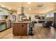 Open kitchen and living room featuring a wood ceiling, island with bar stools, and stainless steel appliances at 1091 Mcfarland St, Dunedin, FL 34698