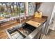 Modern kitchen sink boasts butcher block countertops, stylish backsplash, and a view of the outdoors at 1091 Mcfarland St, Dunedin, FL 34698