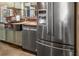 Stainless-steel refrigerator and sink add style to the kitchen with wooden counter tops at 1091 Mcfarland St, Dunedin, FL 34698