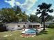 Private backyard featuring an inground pool, well maintained lawn, and mature landscaping for outdoor relaxation at 1101 King Arthur Ct, Valrico, FL 33594