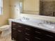 Bathroom featuring a double vanity, wood cabinets, and a shower/tub combo at 1101 King Arthur Ct, Valrico, FL 33594