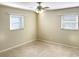 Bright bedroom with two windows, neutral walls, and carpet at 1101 King Arthur Ct, Valrico, FL 33594