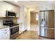 Modern kitchen with stainless steel appliances, granite counters, and white cabinets at 1101 King Arthur Ct, Valrico, FL 33594