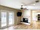 Cozy living room featuring a fireplace, wood-look flooring, and access to the outdoor patio at 1101 King Arthur Ct, Valrico, FL 33594