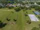 Aerial view of the community with a sports court, dog park, green space and walkways at 12333 Woodlands Cir, Dade City, FL 33525