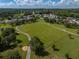 Aerial view of the community's green space, walking trail, and fenced dog park at 12333 Woodlands Cir, Dade City, FL 33525