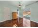 Bedroom with hardwood floors, a large window, and sliding glass doors leading to the outdoor pool area at 12333 Woodlands Cir, Dade City, FL 33525