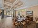 Dining area with wood floors, decorative ceiling, and sliding glass doors leading to the lanai at 12333 Woodlands Cir, Dade City, FL 33525