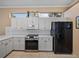 Kitchen featuring white countertops, modern appliances, and lots of cabinet space at 12333 Woodlands Cir, Dade City, FL 33525