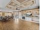 Open living room featuring hardwood floors, a fireplace, and a coffered ceiling at 12333 Woodlands Cir, Dade City, FL 33525