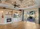 Spacious living room featuring a fireplace, built-in shelving, and sliding glass doors leading to the outside at 12333 Woodlands Cir, Dade City, FL 33525