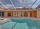 View of the pool area with multiple doors providing access to the house at 12333 Woodlands Cir, Dade City, FL 33525