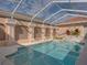 Beautifully designed pool with a screened enclosure, offering privacy and a relaxing outdoor experience at 12333 Woodlands Cir, Dade City, FL 33525