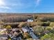 An aerial view of the house, community and nearby pond and greenery at 1242 Holly Cir, Oldsmar, FL 34677