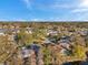 Aerial view showcases a quiet neighborhood surrounded by water features and lush trees at 1242 Holly Cir, Oldsmar, FL 34677