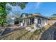 View of back of the house with many windows to enjoy the green backyard with shed at 1242 Holly Cir, Oldsmar, FL 34677