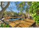 Backyard deck with hammock for relaxing outside and enjoying peaceful waterway views at 1242 Holly Cir, Oldsmar, FL 34677