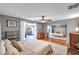 Bright bedroom features wood floors, ceiling fan, and sliding glass doors to an outdoor area at 1242 Holly Cir, Oldsmar, FL 34677