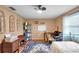 Inviting bedroom filled with natural light, a writing desk, and built-in shelving at 1242 Holly Cir, Oldsmar, FL 34677