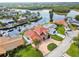 Aerial view of the waterfront home with a red roof shows the pool and dock at 1336 51St Ne Ave, St Petersburg, FL 33703