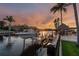 Waterfront property with a boat dock, boat lift, kayaks, and tiki hut in the background at 1336 51St Ne Ave, St Petersburg, FL 33703