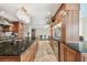 Open kitchen featuring dark countertops, wood cabinets, and seamless flow to dining area at 1336 51St Ne Ave, St Petersburg, FL 33703