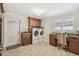 Well-equipped laundry room with built-in cabinets, granite countertops, and tile flooring at 1336 51St Ne Ave, St Petersburg, FL 33703