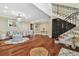 Inviting living room featuring hardwood floors, chandelier, and adjacent staircase with iron railing at 1336 51St Ne Ave, St Petersburg, FL 33703