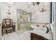 Main bathroom featuring a glass enclosed shower, soaking tub, dual vanities, and tile flooring at 1336 51St Ne Ave, St Petersburg, FL 33703