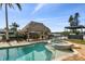 Sparkling pool and spa with a tiki hut overlooking the waterfront canal at 1336 51St Ne Ave, St Petersburg, FL 33703