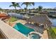 Backyard pool area with tiki hut, tropical landscaping and boat dock at 1336 51St Ne Ave, St Petersburg, FL 33703