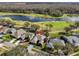 Aerial view of home with a pool, overlooking a golf course and pond at 1401 Ventana Dr, Sun City Center, FL 33573