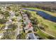 An aerial view of a neighborhood with golf course and water views at 1401 Ventana Dr, Sun City Center, FL 33573