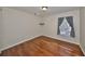 Bedroom featuring hardwood floors, neutral walls, and a window with privacy blinds at 1401 Ventana Dr, Sun City Center, FL 33573