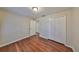 Bedroom featuring hardwood floors, neutral walls, and double closets at 1401 Ventana Dr, Sun City Center, FL 33573