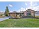 Charming one-story house showcasing manicured landscaping and a well-maintained lawn at 1401 Ventana Dr, Sun City Center, FL 33573