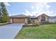 Charming single-story home with a well-manicured lawn and a two-car garage at 1401 Ventana Dr, Sun City Center, FL 33573