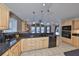 Open kitchen with stone countertops, breakfast bar and view into living area at 1401 Ventana Dr, Sun City Center, FL 33573