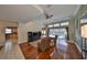 Open concept living room featuring hardwood floors, entertainment center, and a view of the pool at 1401 Ventana Dr, Sun City Center, FL 33573