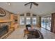 Living room features brick fireplace, vaulted ceilings and views of pool at 1401 Ventana Dr, Sun City Center, FL 33573