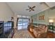 Comfortable living room with hardwood floors, ceiling fan, and sliding doors to the pool area at 1401 Ventana Dr, Sun City Center, FL 33573